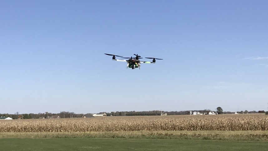 A 3D-Printed Quadcopter flying in front of some cornfields